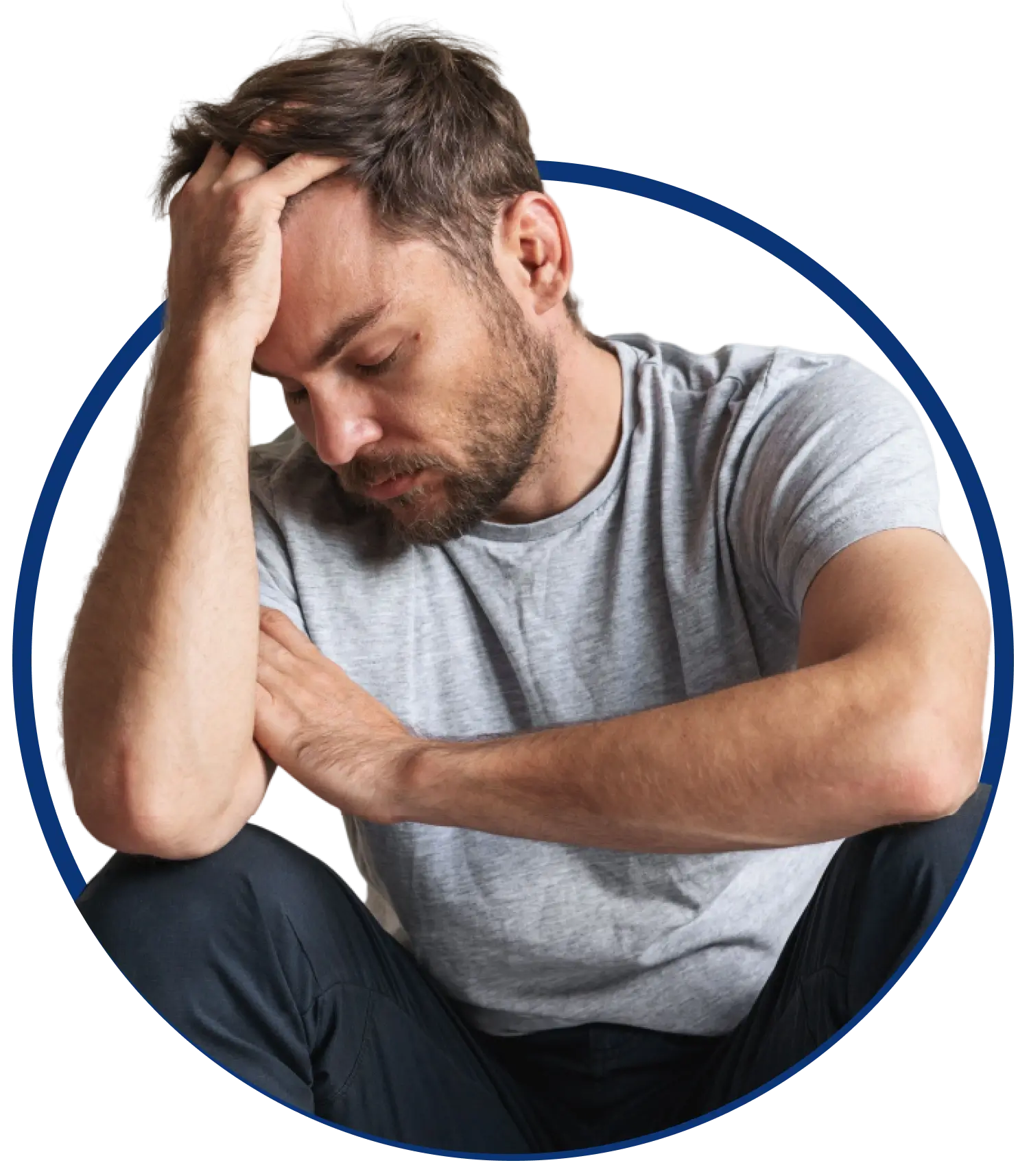 bearded man sitting, holding head in thought